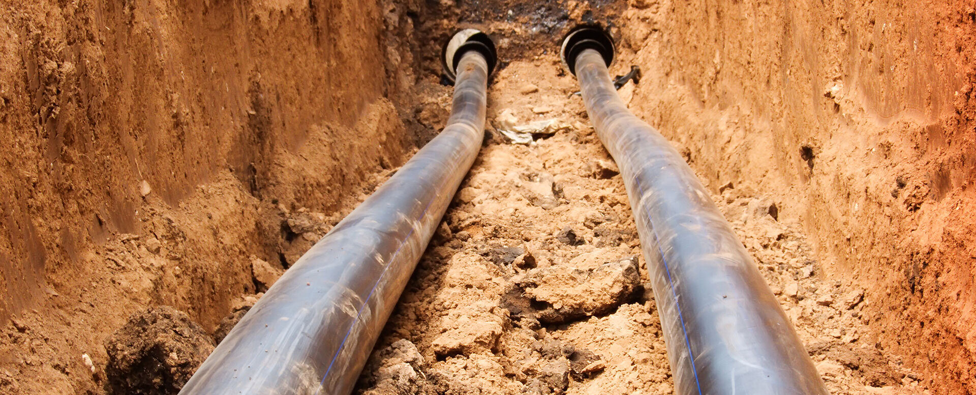 Two pipes in trench
